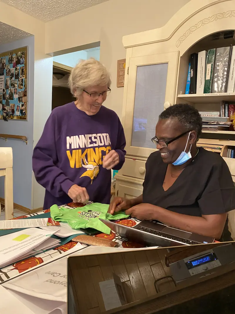 Caregiver and resident working on a craft