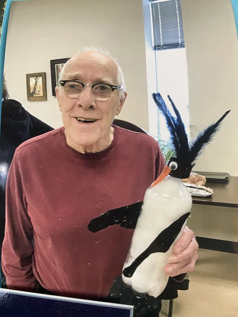Resident proudly holding a craft project