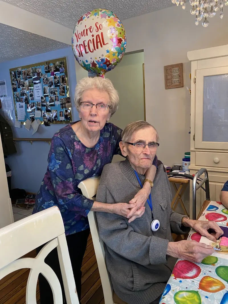 Two residents smiling together at a celebration
