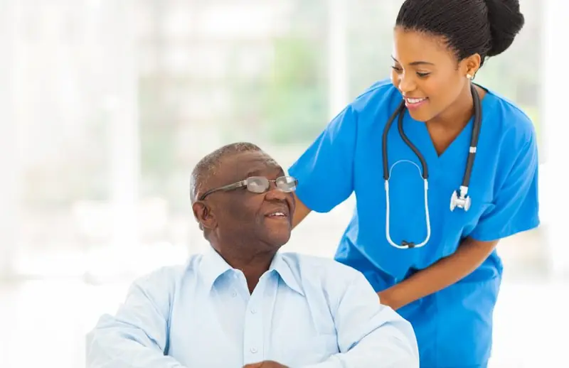 Nurse checking in with a smiling older man